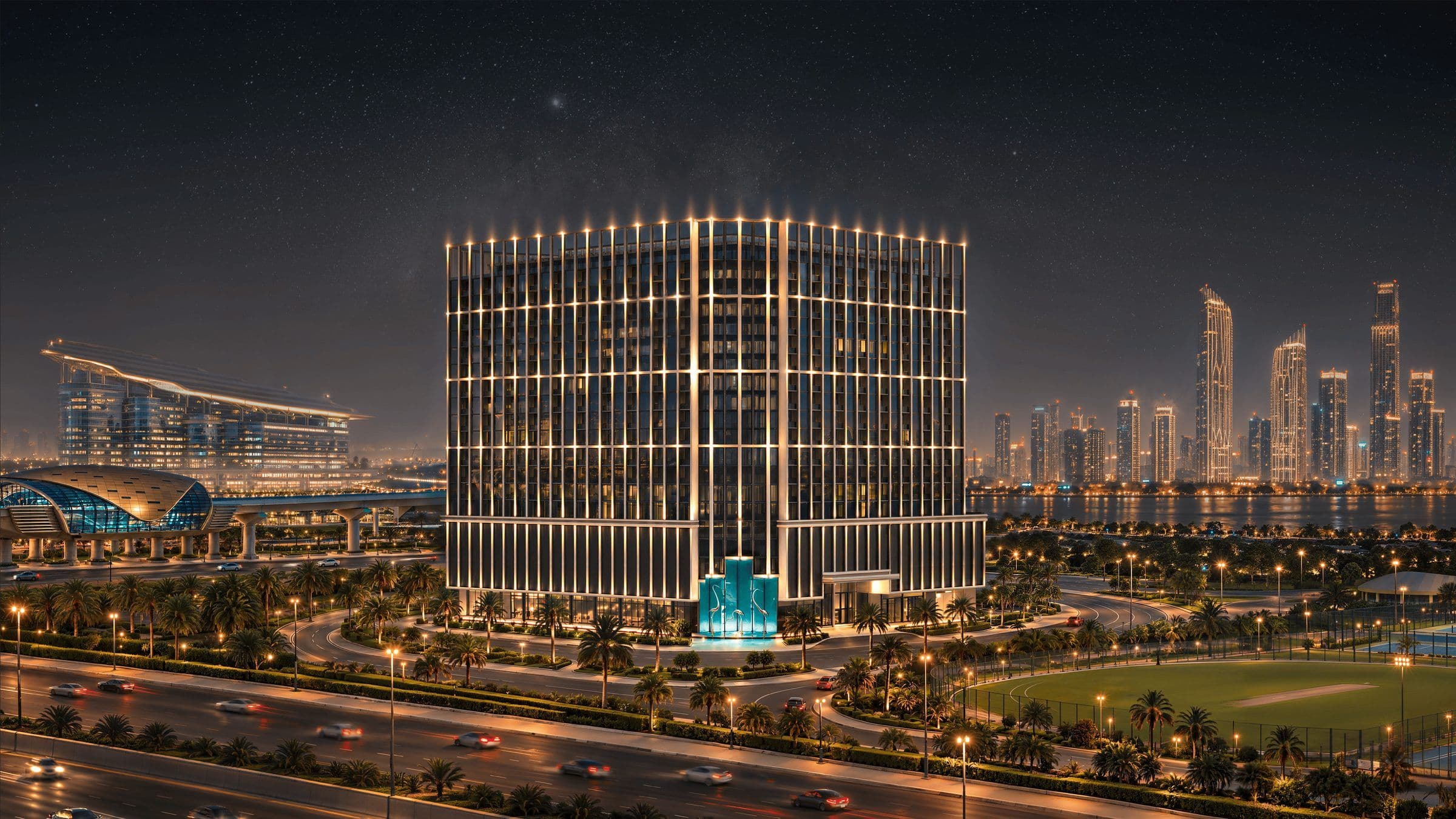 Binghatti Starfall tower lit up at night with the Dubai skyline behind